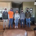 first CAF install in missouri, group stands in customers home following install